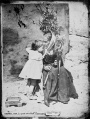 Abuela hilando con niña de 2 años (1860s).jpg